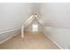 Large attic bedroom with window and carpet at 945 Eugene St, Indianapolis, IN 46208