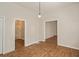Dining area with hardwood floors, view of bathroom and hallway at 945 Eugene St, Indianapolis, IN 46208