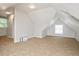 Spacious bonus room featuring sloped ceilings and a large window at 945 Eugene St, Indianapolis, IN 46208
