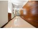 Modern hallway with wood wall paneling and polished floors at 1 Virginia Ave # 606, Indianapolis, IN 46204