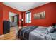 Bright bedroom with red walls, large window, and comfortable bed at 1 Virginia Ave # 606, Indianapolis, IN 46204