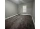 Simple bedroom with neutral carpeting and one window at 815 W 22Nd St, Anderson, IN 46016
