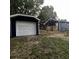 Side view of a navy blue house with a detached garage at 815 W 22Nd St, Anderson, IN 46016