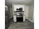 Updated kitchen with stainless steel appliances and white cabinets at 815 W 22Nd St, Anderson, IN 46016