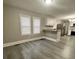 Open concept dining area, grey vinyl flooring, and kitchen access at 815 W 22Nd St, Anderson, IN 46016