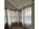 Bright bedroom with two windows and patterned curtains at 808 E Minnesota St, Indianapolis, IN 46203