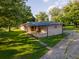 Brick ranch house with a covered porch and ample yard space at 2129 Woodcrest Rd, Indianapolis, IN 46227