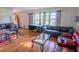 Bright living room featuring hardwood floors, large windows, and comfortable seating at 2129 Woodcrest Rd, Indianapolis, IN 46227