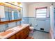 Retro bathroom with double sinks and light blue tile at 2129 Woodcrest Rd, Indianapolis, IN 46227