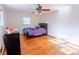 Hardwood floor bedroom with a double bed and ceiling fan at 2129 Woodcrest Rd, Indianapolis, IN 46227