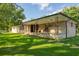 Brick ranch house with a covered porch and spacious lawn at 2129 Woodcrest Rd, Indianapolis, IN 46227