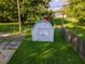 Small grey shed in backyard with green grass at 2129 Woodcrest Rd, Indianapolis, IN 46227