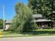 House with a weeping willow tree in front at 643 Pratt St, Greenfield, IN 46140