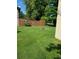 Large backyard with grassy area and wooden fence at 643 Pratt St, Greenfield, IN 46140