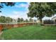 Landscaped backyard with pond and wooden fence at 9650 Shasta Dr, Fishers, IN 46038