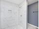 Large walk-in shower with marble tile and glass door at 1136 W 35Th St, Indianapolis, IN 46208
