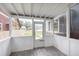 Bright screened porch with wood flooring and backyard view at 1136 W 35Th St, Indianapolis, IN 46208
