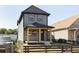 Two-story house with gray siding, a covered porch, and a fenced yard at 1438 S Illinois St, Indianapolis, IN 46225