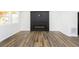 Living room with hardwood floors, an electric fireplace, and shiplap wall at 1438 S Illinois St, Indianapolis, IN 46225