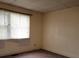 Empty bedroom with window and neutral walls at 6380 E 10Th St, Indianapolis, IN 46018
