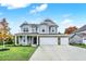 Two-story house with gray siding, white pillars, and a two-car garage at 4756 Bethel Creek Blvd, Indianapolis, IN 46239