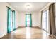 Bright dining room with hardwood floors and two windows with teal curtains at 4130 Robertson Ct, Indianapolis, IN 46228