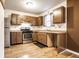 Galley kitchen with wood cabinets, stainless steel appliances, and wood floors at 4130 Robertson Ct, Indianapolis, IN 46228