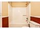 Bathroom with tub shower, toilet and laminate floor at 4130 Robertson Ct, Indianapolis, IN 46228