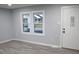 Living room with gray walls, wood-look vinyl flooring, and windows at 1215 E Kelly St, Indianapolis, IN 46203