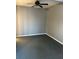 Simple bedroom with gray walls and carpeting, ceiling fan at 6104 Madison Ave, Indianapolis, IN 46227