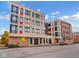 Three-story modern building with multiple units and street parking at 319 E 16Th St # 207, Indianapolis, IN 46202