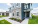Two-story home with stone and blue siding, welcoming front entrance and landscaping at 1448 Buttercup Ln, Shelbyville, IN 46176