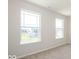 Bright bedroom with two large windows and carpet at 1448 Buttercup Ln, Shelbyville, IN 46176
