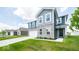 Two-story home with gray siding, stone accents, and a white garage door at 1448 Buttercup Ln, Shelbyville, IN 46176