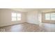 Spacious living room with large windows and wood-look floors at 1448 Buttercup Ln, Shelbyville, IN 46176
