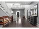 Grand two-story entryway with hardwood floors, a curved staircase, and stylish decor at 9825 Windy Hills Dr, Zionsville, IN 46077