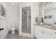 Modern bathroom with walk-in shower and white cabinetry at 9825 Windy Hills Dr, Zionsville, IN 46077