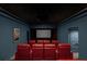 Home theater with red reclining seats and a star ceiling at 9825 Windy Hills Dr, Zionsville, IN 46077