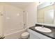 Clean bathroom with tub, toilet and dark vanity top at 11021 Underwood Ct, Indianapolis, IN 46235