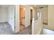 Upstairs hallway with bathroom and bedrooms access, grey carpet at 11021 Underwood Ct, Indianapolis, IN 46235