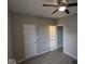 Bedroom with gray walls, wood-look flooring, and two white doors at 213 E Broadway St, Alexandria, IN 46001
