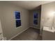 Simple bedroom with two windows and vinyl flooring at 213 E Broadway St, Alexandria, IN 46001