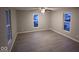 Bright bedroom featuring two windows and ceiling fan at 213 E Broadway St, Alexandria, IN 46001