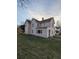 Two-story house with light beige siding, a large yard, and mature trees at 213 E Broadway St, Alexandria, IN 46001