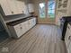 Modern kitchen with white cabinets and vinyl flooring at 213 E Broadway St, Alexandria, IN 46001