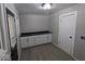 Bright laundry room with white cabinets and vinyl flooring at 213 E Broadway St, Alexandria, IN 46001