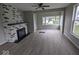 Living room with gray walls, a fireplace, and wood-look flooring at 213 E Broadway St, Alexandria, IN 46001