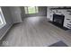 Living room with gray walls, wood-look flooring, and a fireplace at 213 E Broadway St, Alexandria, IN 46001