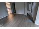 Living room with gray walls, wood-look flooring, and views into other rooms at 213 E Broadway St, Alexandria, IN 46001