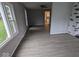 Living room with gray walls, wood-look flooring, and a view into the kitchen at 213 E Broadway St, Alexandria, IN 46001